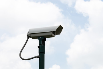 Security camera on blue sky background