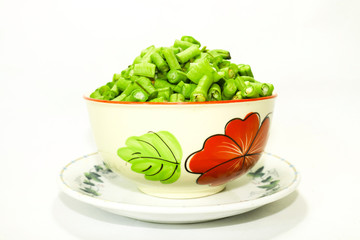  Long beans hatched into plates, placed on a plate on a white background