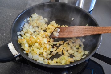 Chopped fried in a pan in the kitchen.