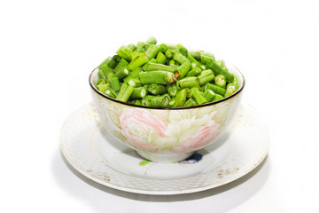  Long beans hatched into plates, placed on a plate on a white background