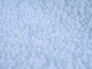 White little polystyrene foam balls. background of many foam.