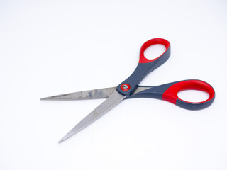 Old gray and red scissors on the White Blackground