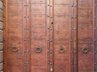 old wooden door on the wall of an italian house