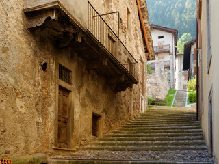 Fototapeta premium old wooden door on the wall of an italian house