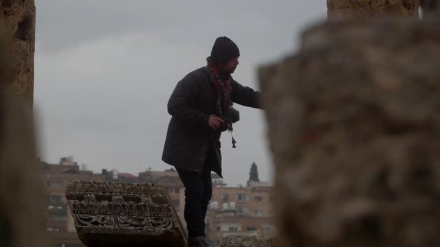 photographer in Jerash ancient Roman ruins in front of the city
