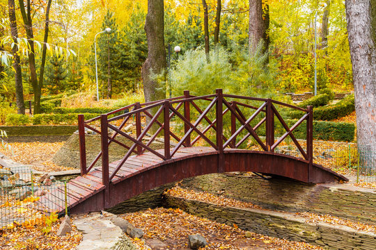 Wooden bridge in the autumn park. © marketlan