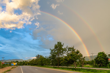 Double rainbow appearing after rain seen from roadside near Lampang province of Thailand