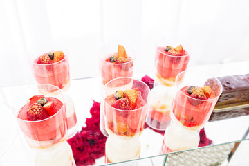 Candy bar with a lot of desserts, meringue, cupcake, fruit and sweet cakes. Sweet table for birthday or wedding.