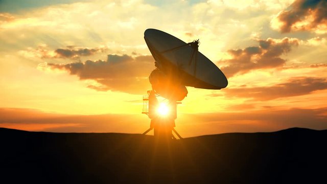 Huge military radar raising its antenna dish exploring evening sky against scenic sunset. Military position range radar systems are used in location of enemy army forces to prevent sudden attacks