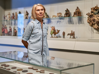 Mature woman looking at exhibit.