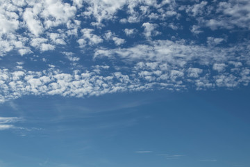 Small white fluffy cloud in the blue sky