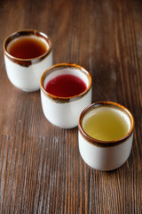Different tea in teapots on a dark wooden background. catering menu