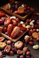 Various dried fruits and nuts in wooden dish.