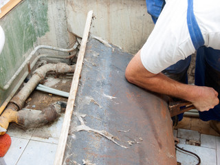 plumber fixing  old bath