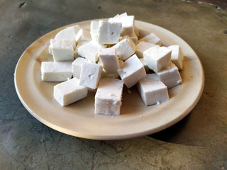 fresh cheese slice put in a plate isolated on stone background