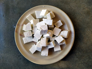 fresh cheese slice put in a plate isolated on stone background