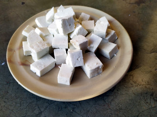 fresh cheese slice put in a plate isolated on stone background