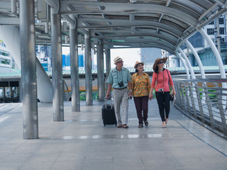 elderly group walking in walk way in city,elder man and woman travel in holiday