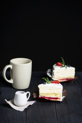 tasty cake with white cream and strawberries on a dark background
