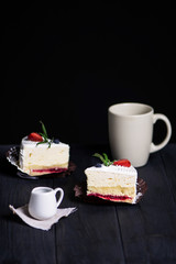 tasty cake with white cream and strawberries on a dark background