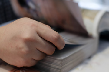 Close up of student hand opening and reading a book.