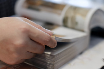 Close up of student hand opening and reading a book.