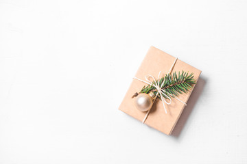 Fototapeta na wymiar Christmas gift with fir branch on white background. Flat lay, top view. Copy space foryour text.