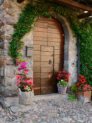 old wooden door on the wall of an italian house