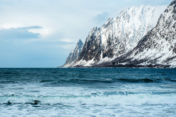 Dramatic winter sea and epic snowy mountains, Lofoten islands in Norway