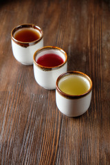 Different tea in teapots on a dark wooden background. catering menu