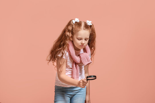 Little Girl With Magnifying Glass On Color Background