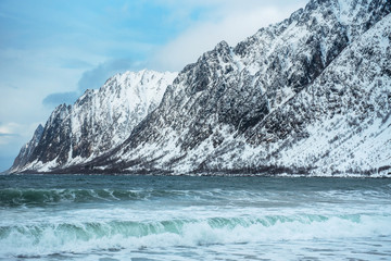 Dramatic winter sea and epic snowy mountains, Lofoten islands in Norway