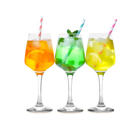 Glasses of tasty summer cocktails on white background