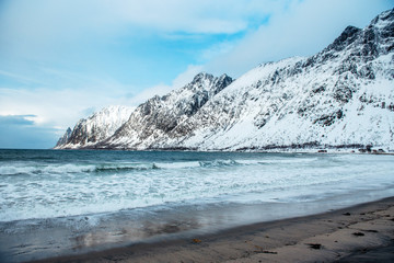 Dramatic winter sea and epic snowy mountains, Lofoten islands in Norway