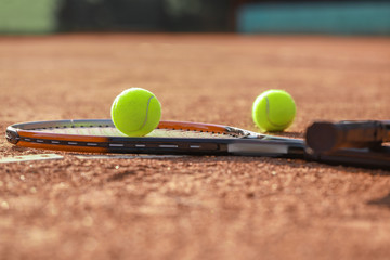 Racket and balls on tennis court
