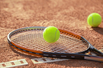 Racket and balls on tennis court