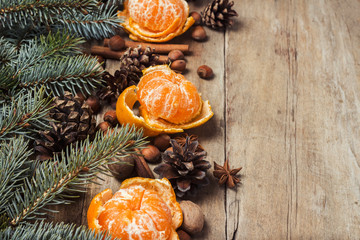 Tangerines, Christmas tree branches, cones, spices on a wooden background. Concept of New Year and Christmas, Christmas drink Mulled wine.