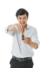 Smiling asian man holding amber glass serum bottle with dropper isolated on white background