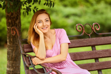 Woman relaxing on bench in park