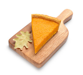 Board with piece of tasty pumpkin pie on white background