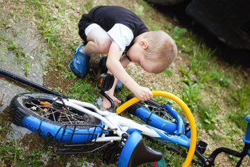 Boy is repairing a bike.