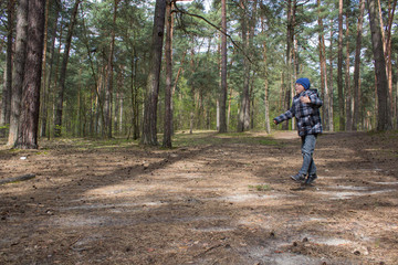boy jumps in the forest,happy boy runs and jumps in pine forest