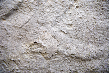 Old red brick wall. Old concrete wall. The facade of the house built of solid stone cement
