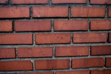 Old red brick wall. Old concrete wall. The facade of the house built of solid stone cement