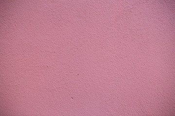 Old red brick wall. Old concrete wall. The facade of the house built of solid stone cement