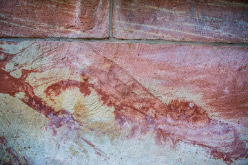 Old red brick wall. Old concrete wall. The facade of the house built of solid stone cement