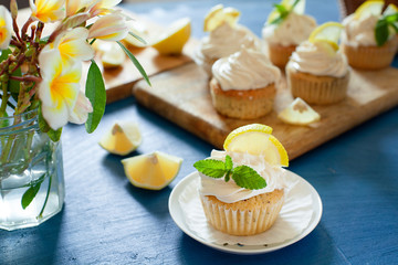 Lemon cupcakes with poppy seeds, white butter cream and  slice of lemon