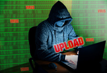 Man in hoodie is hacking personal data on green background. Information security. Upload process...