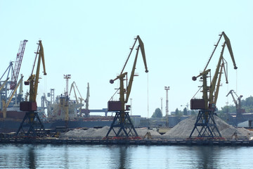 Fototapeta na wymiar Industrial view of sea port warehouse, cranes and ships. Import export, global logistics concept.