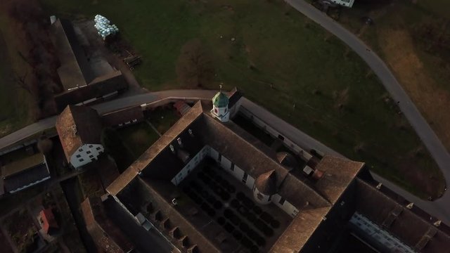Aerial drone shot orbiting increasingly around Fahr Monastery in Unterengstringen, Switzerland 60fps